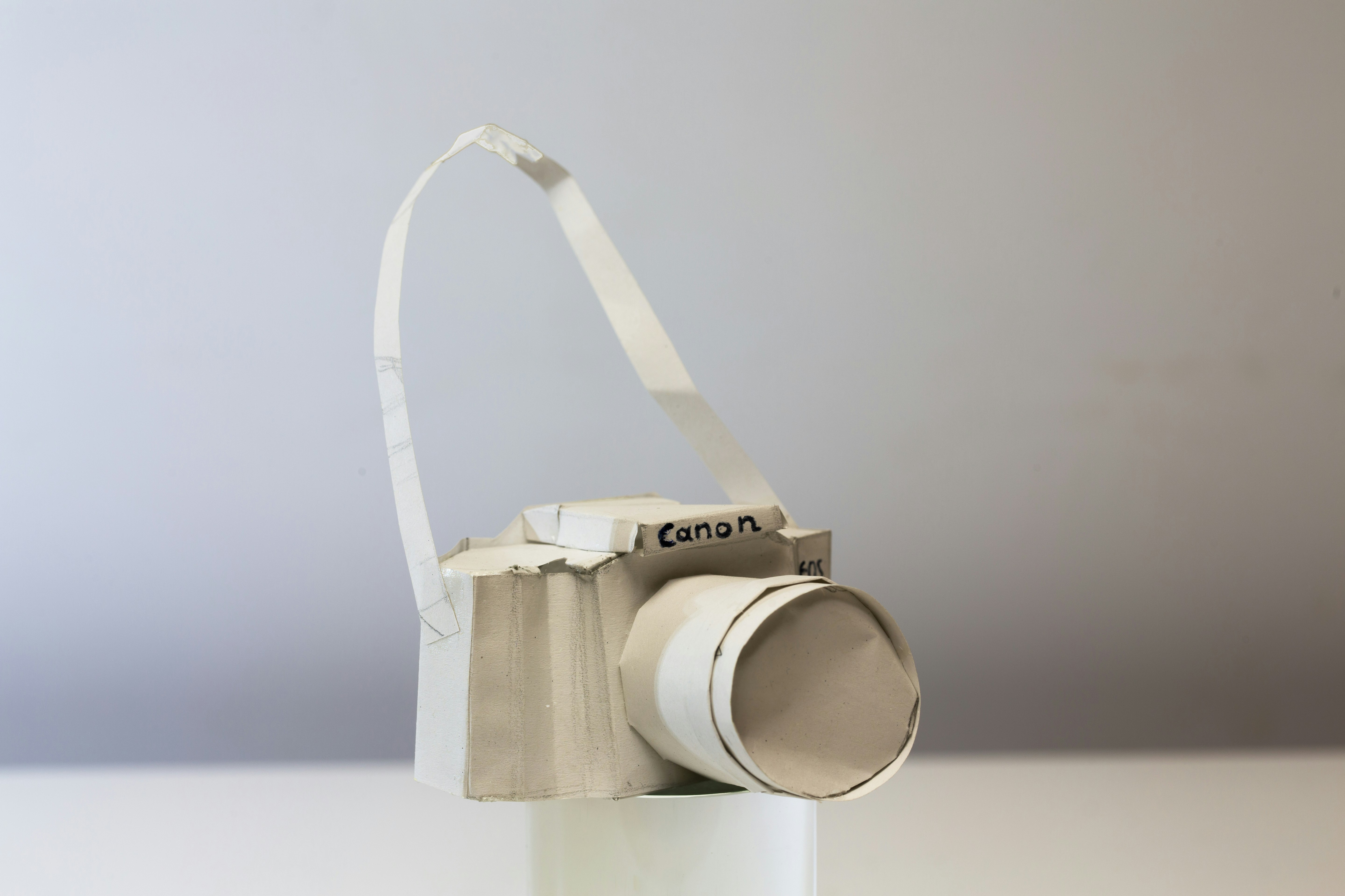white and silver camera on white table